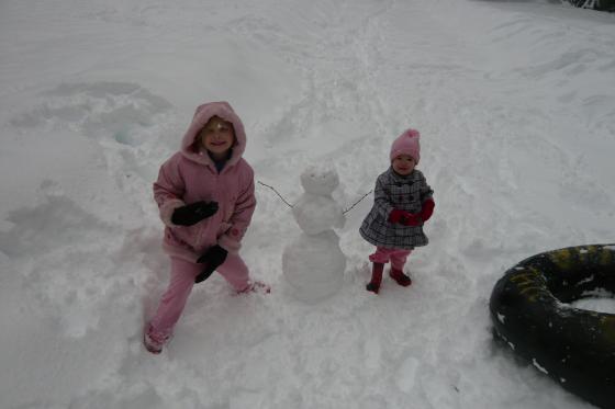 Sophie and Lillie with their snowman